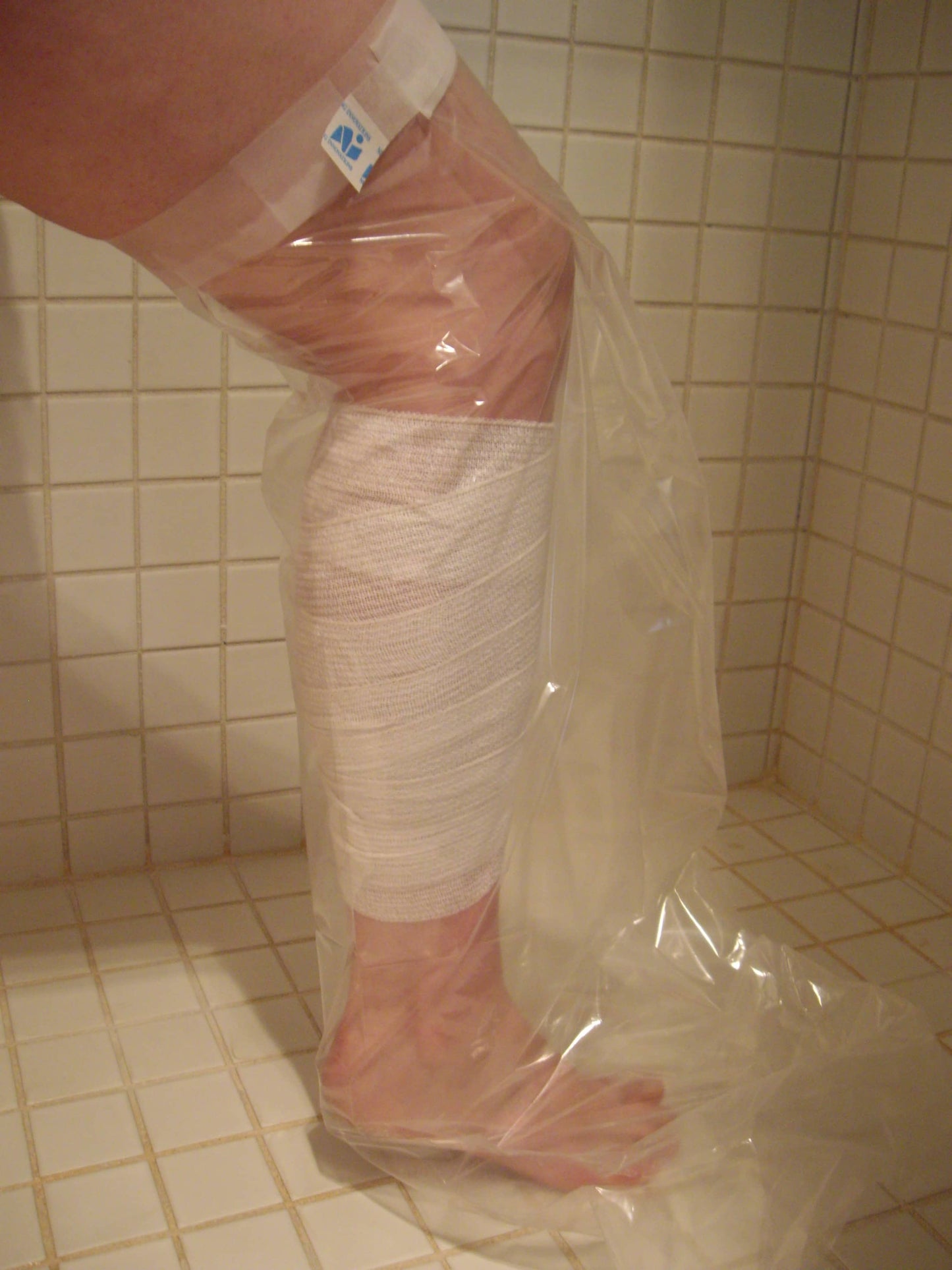nursing innovations blue bag protector in use in the shower