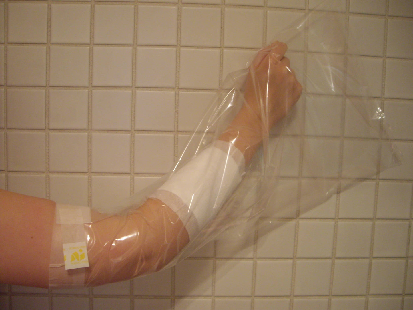 nursing innovations yellow bag protector in use in the shower